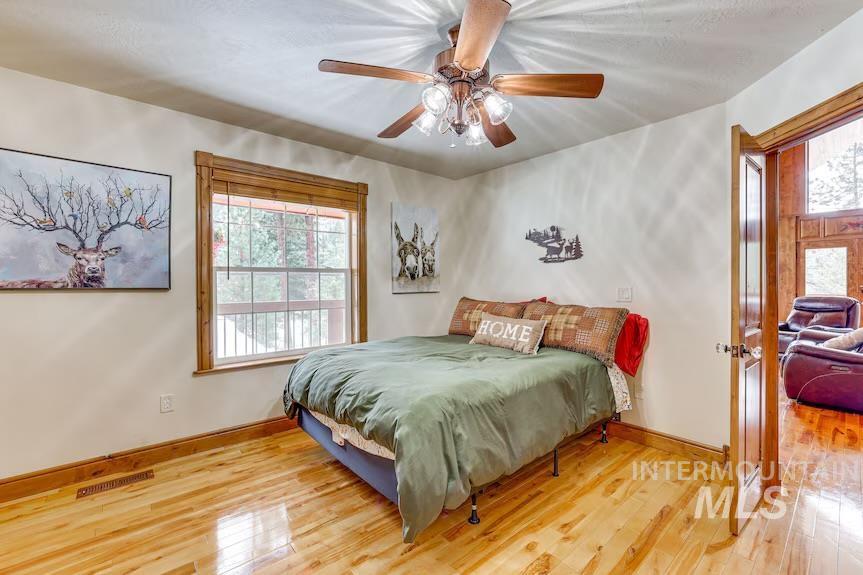Bedroom featuring wood finished floors and a ceiling fan