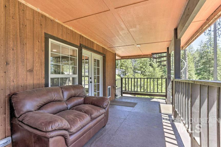 Covered porch featuring french doors