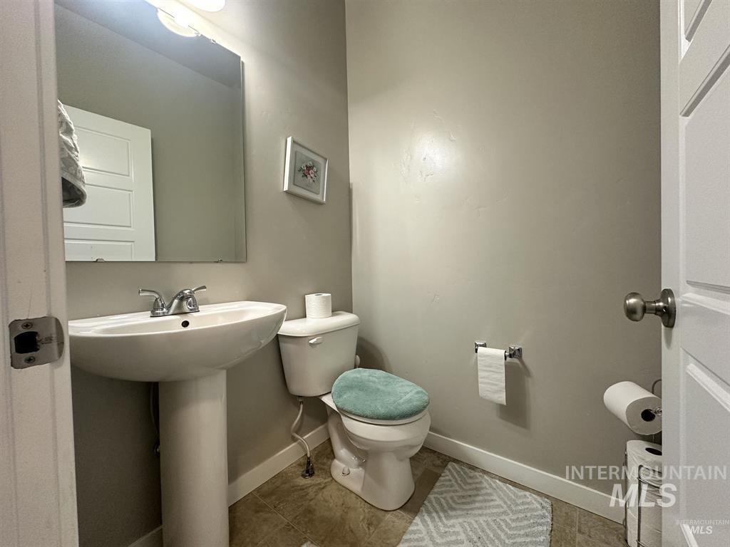 Bathroom with toilet and tile patterned flooring