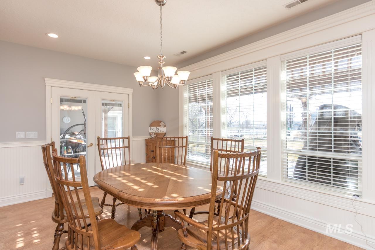 Dining space featuring a wainscoted wall and a chandelier