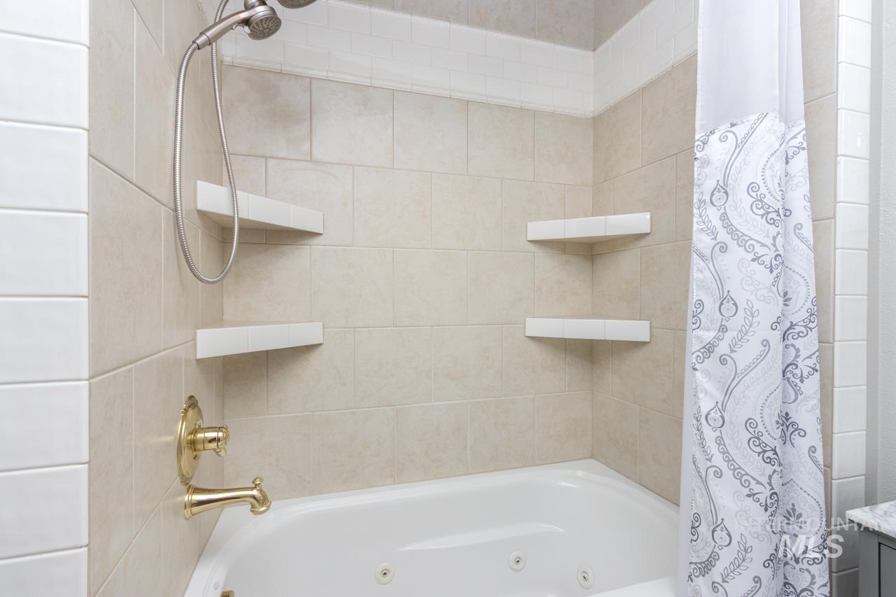 Full bath with a combined bath / shower with jetted tub