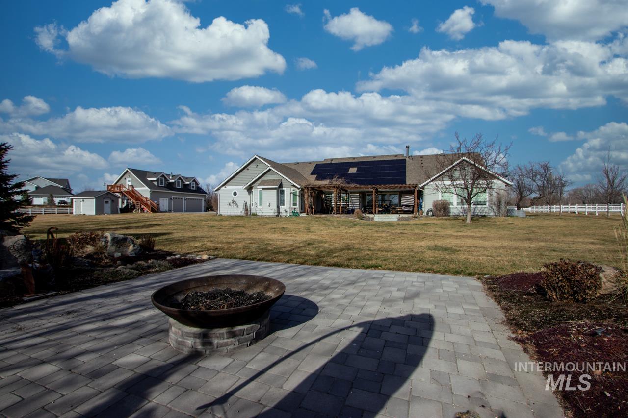 View of patio / terrace with an outdoor fire pit and a pergola