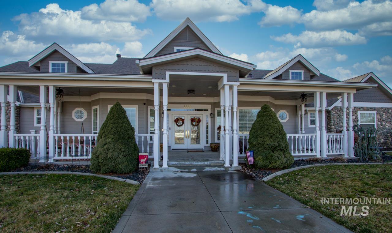 View of front of home with covered porch and a front yard