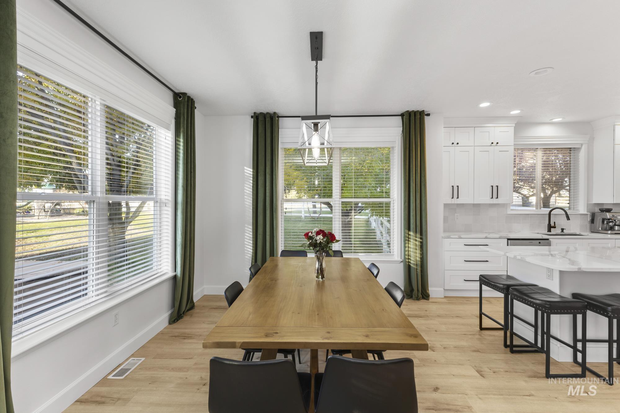 Dining area featuring light wood finished floors and recessed lighting