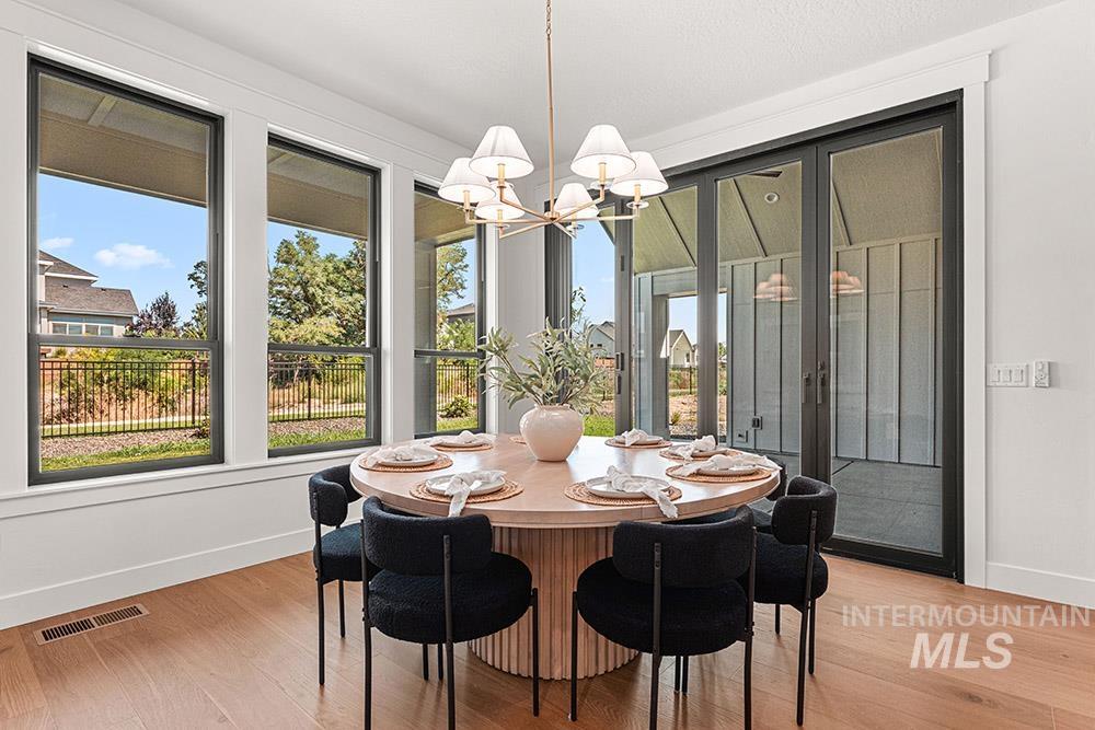 Dining room with a chandelier and light wood-style flooring