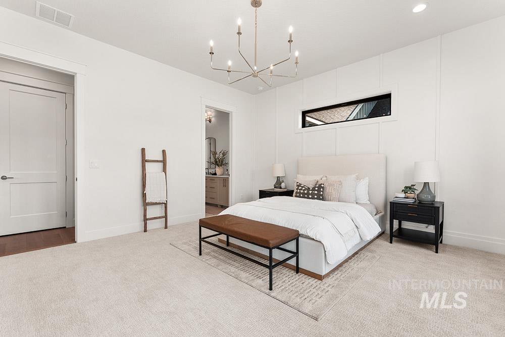 Bedroom featuring carpet, connected bathroom, a chandelier, and recessed lighting