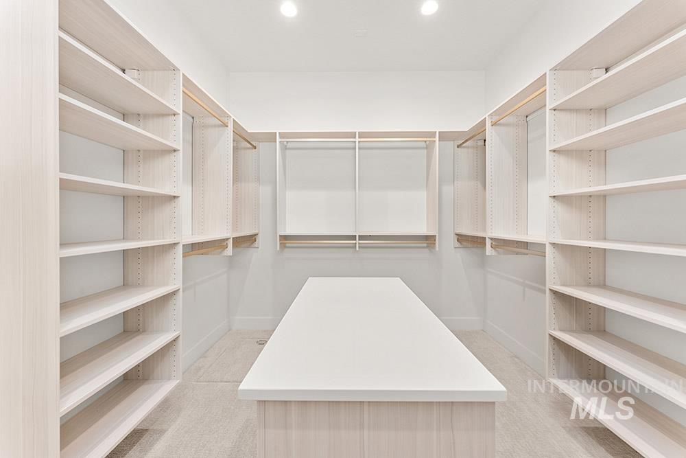 Spacious closet with light colored carpet