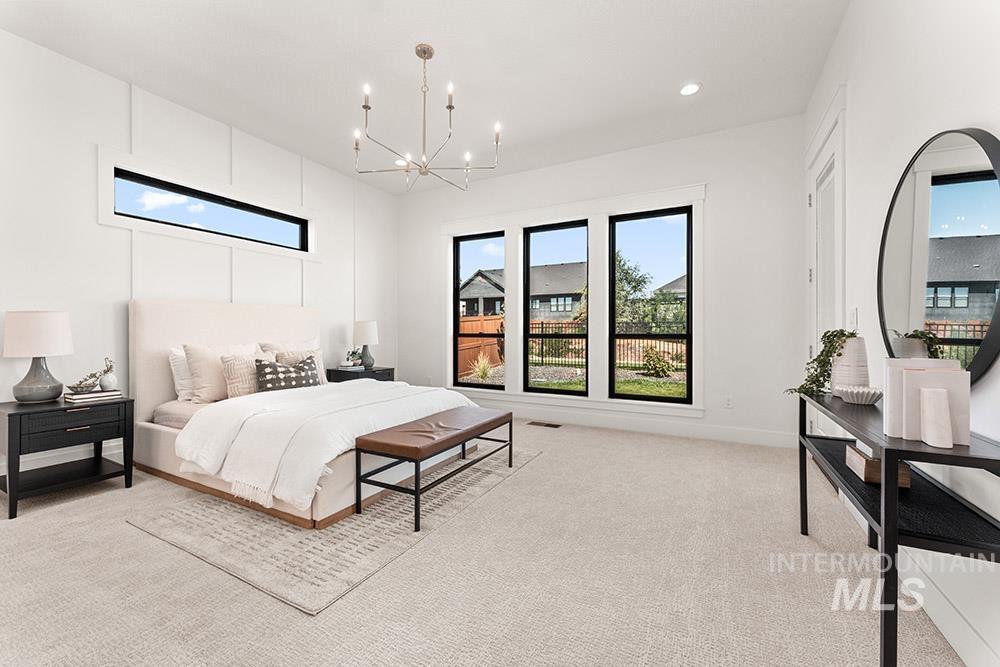 Bedroom featuring light carpet, a chandelier, and recessed lighting
