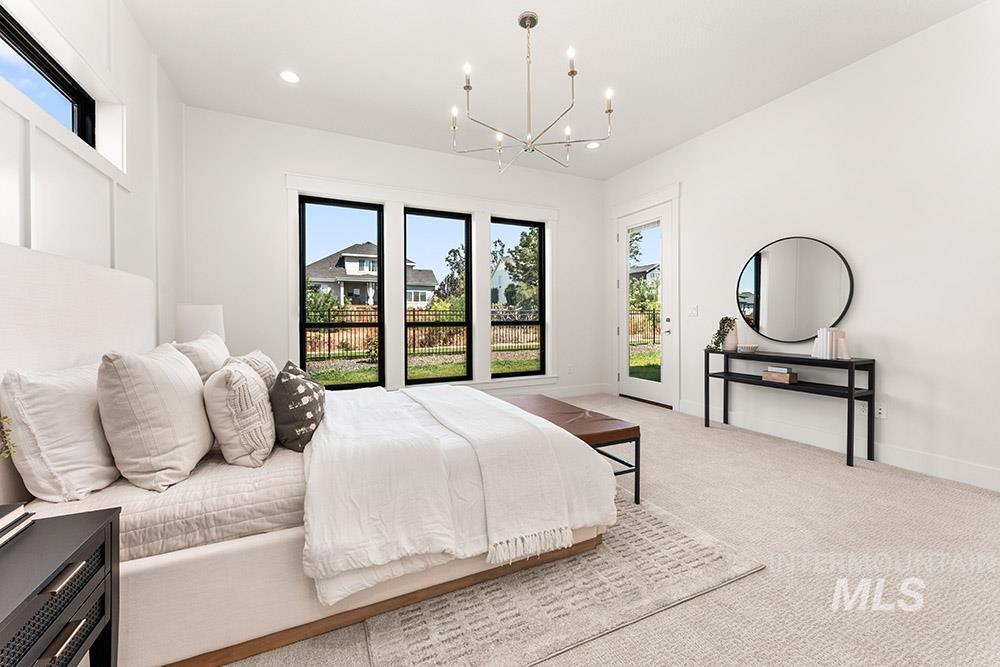 Bedroom with carpet flooring, recessed lighting, access to outside, and a chandelier