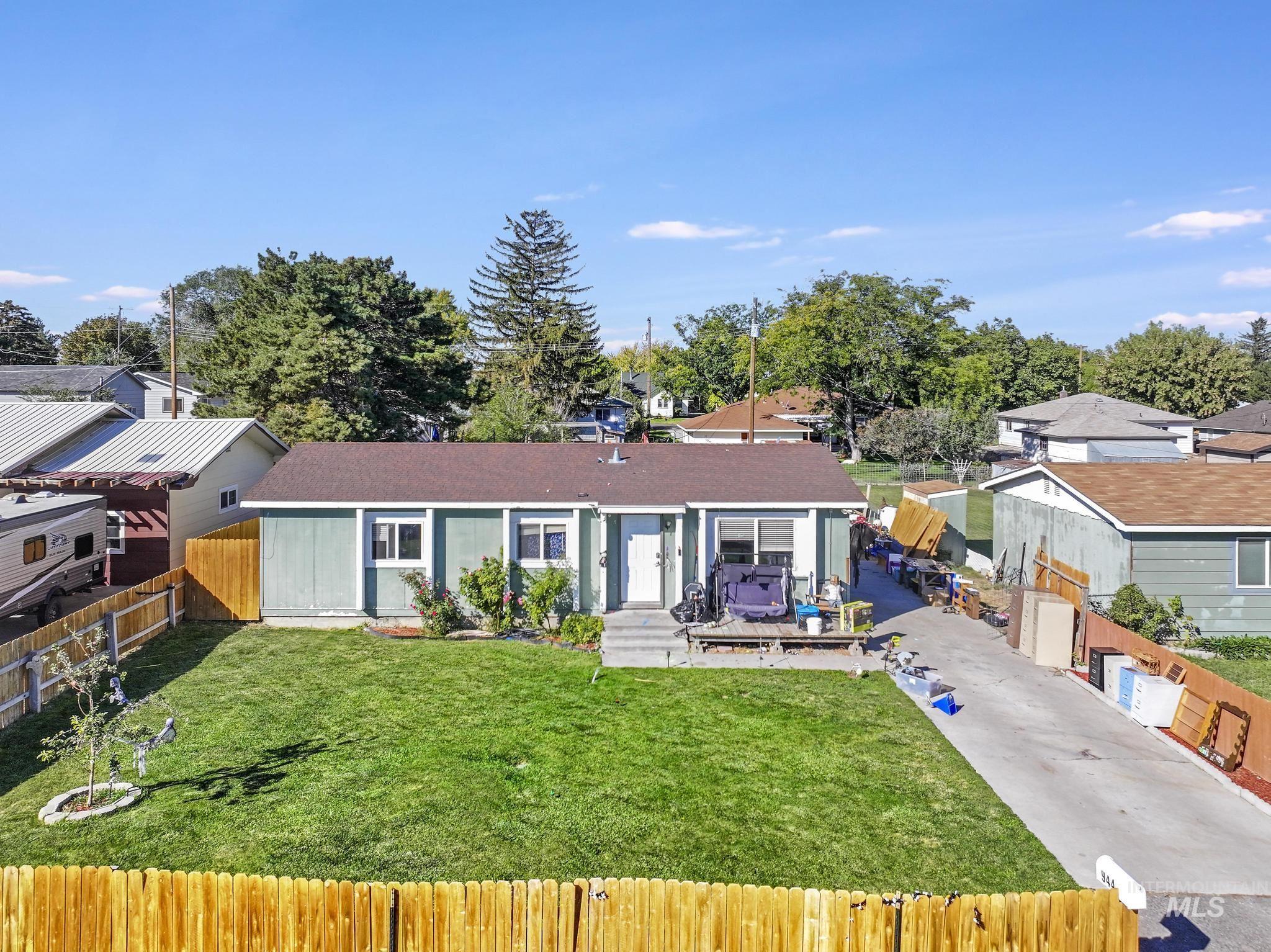 View of front of home with a fenced front yard and driveway