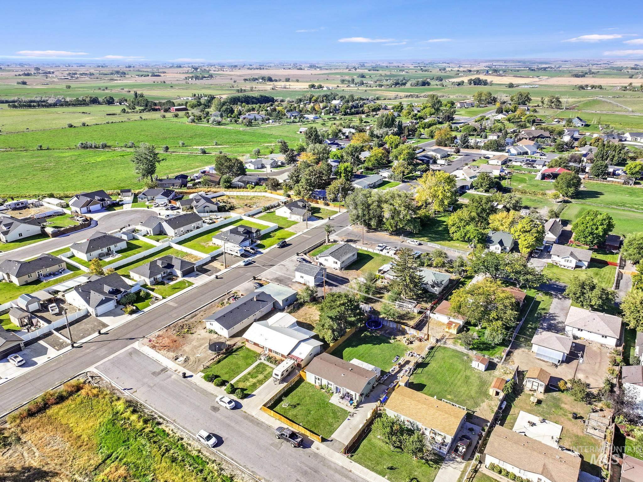 Aerial view of property's location with nearby suburban area