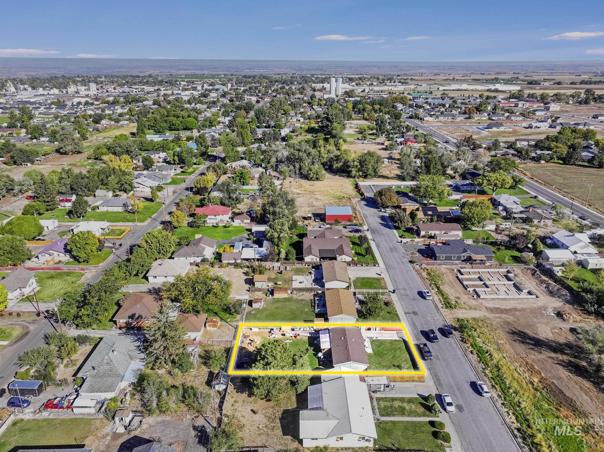 Aerial perspective of suburban area featuring property boundaries highlighted