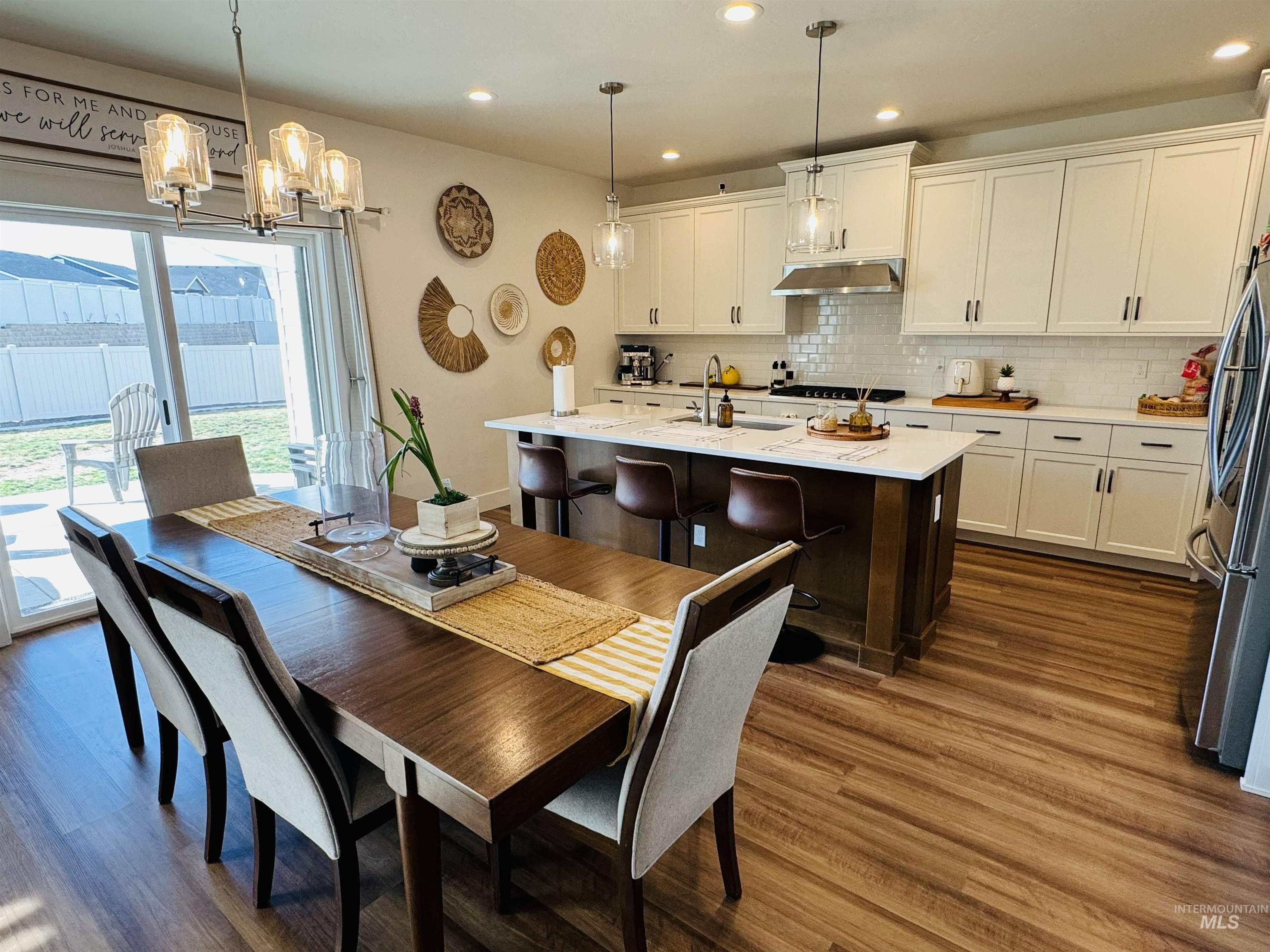 Dining area featuring a chandelier and dark wood finished floors