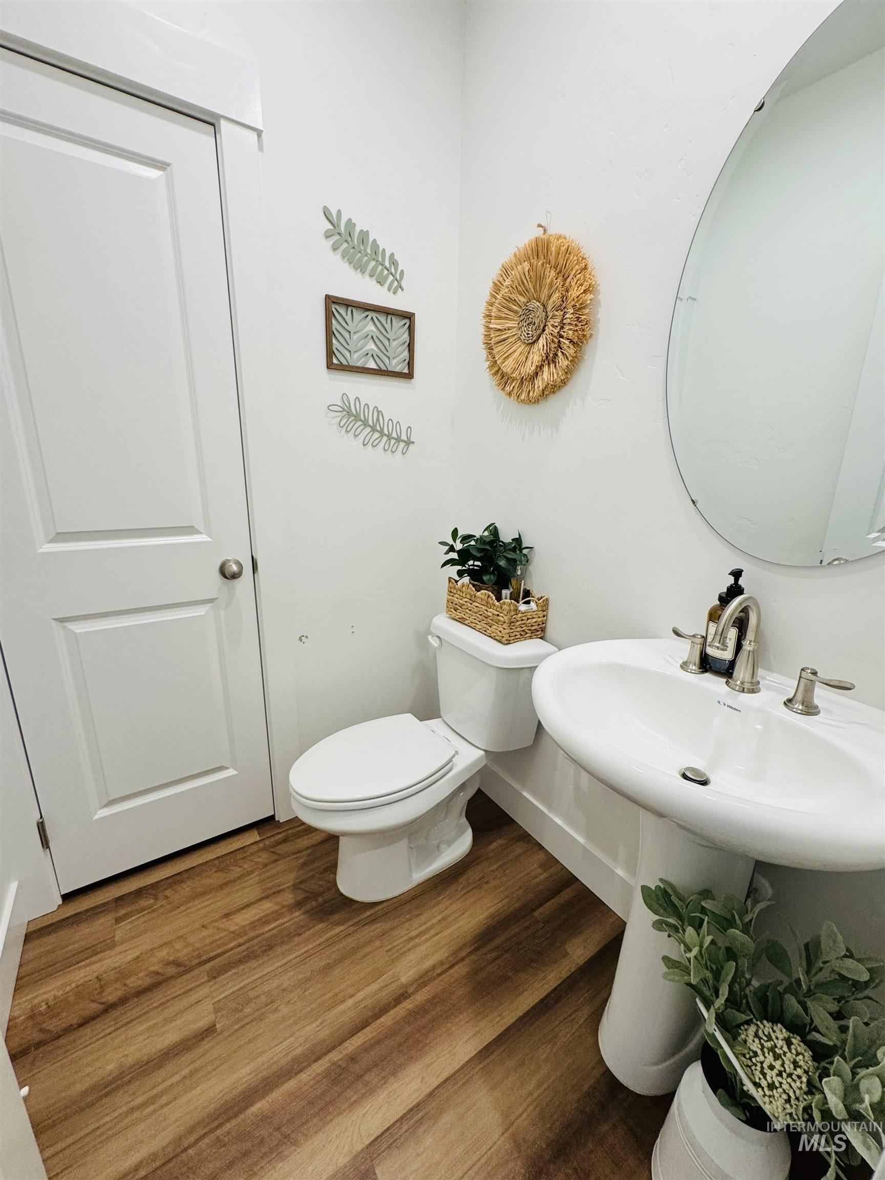 Bathroom featuring toilet and wood finished floors