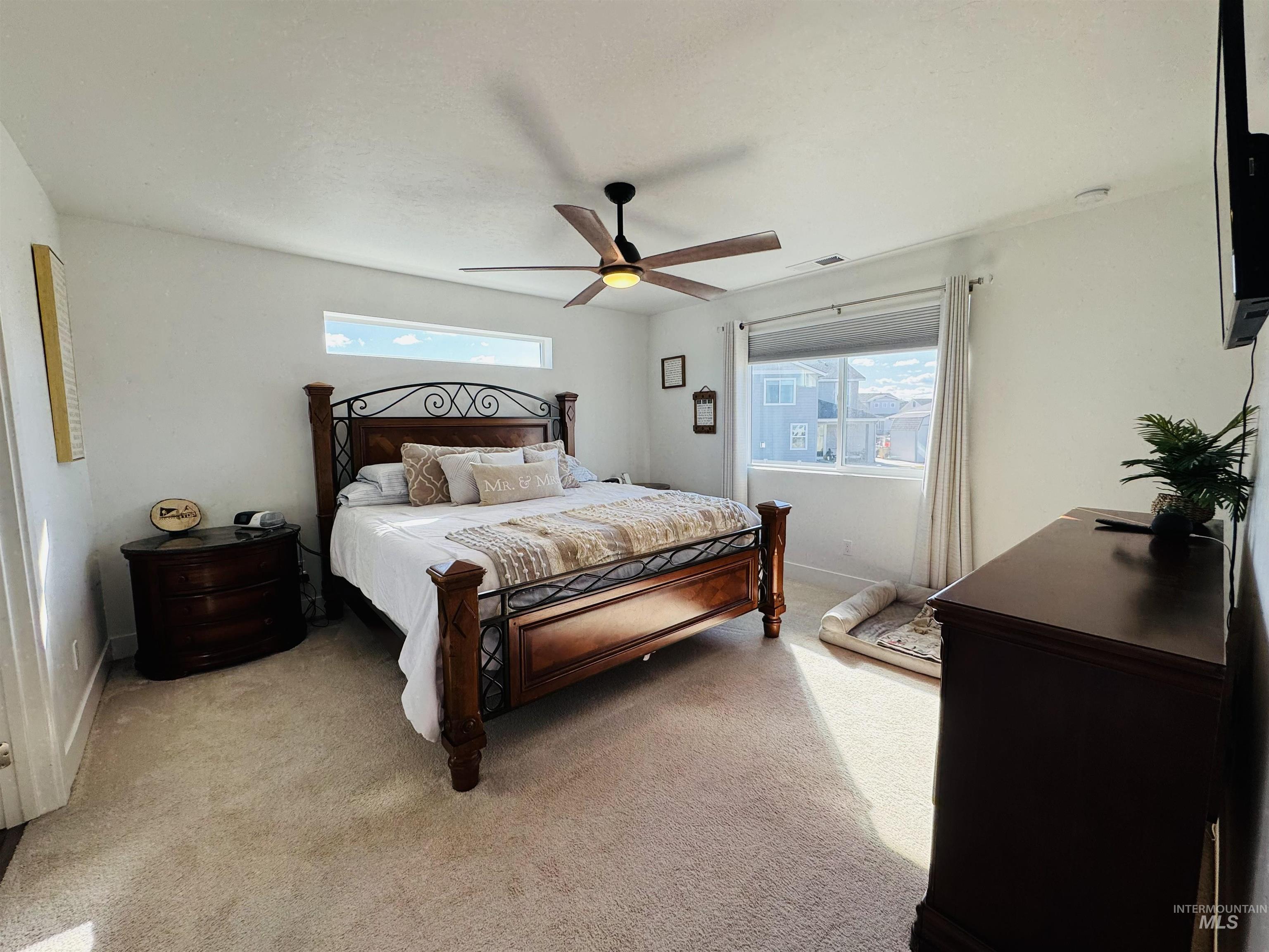 Bedroom with light colored carpet and ceiling fan