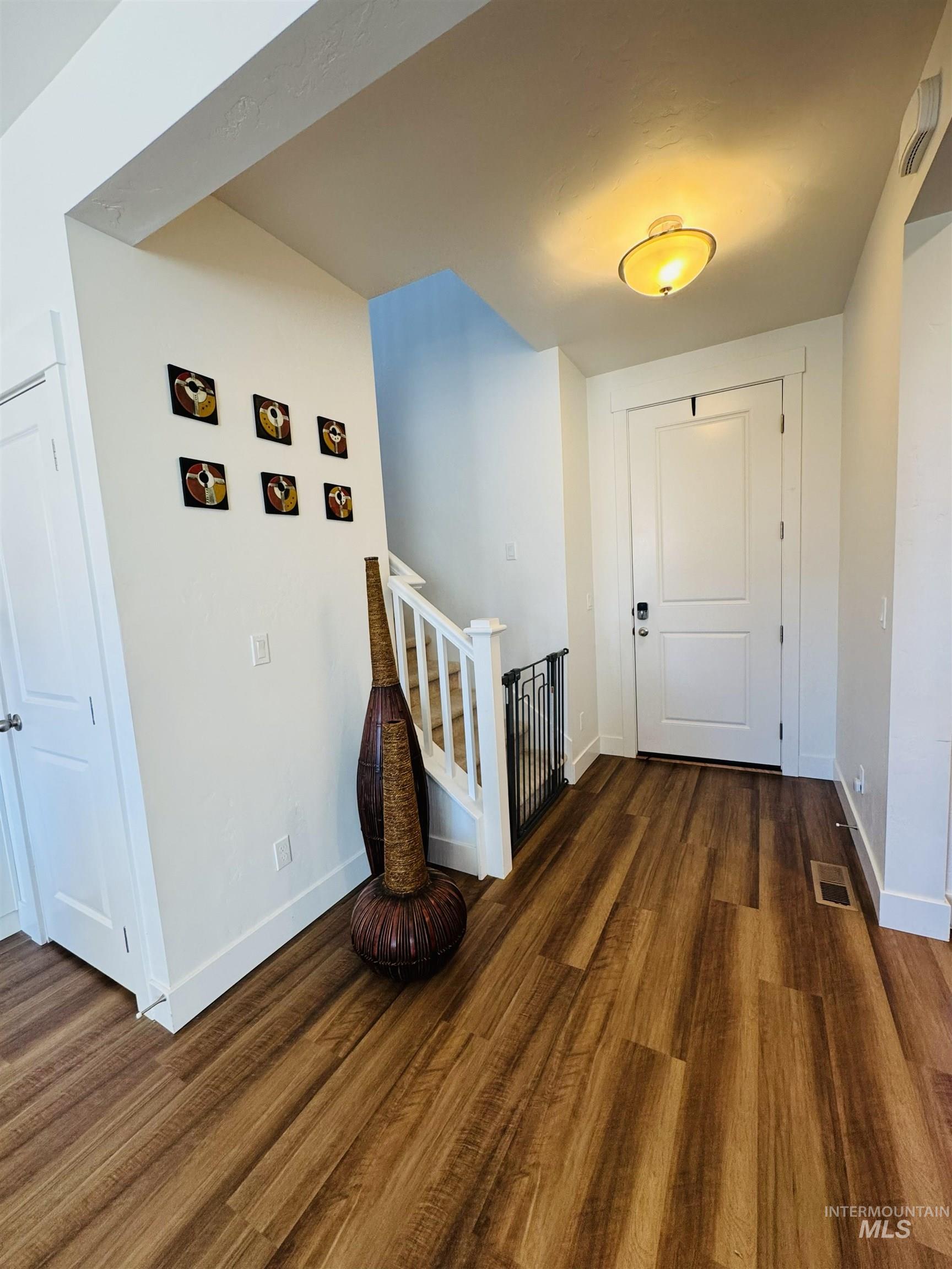 Hall featuring stairway and dark wood finished floors
