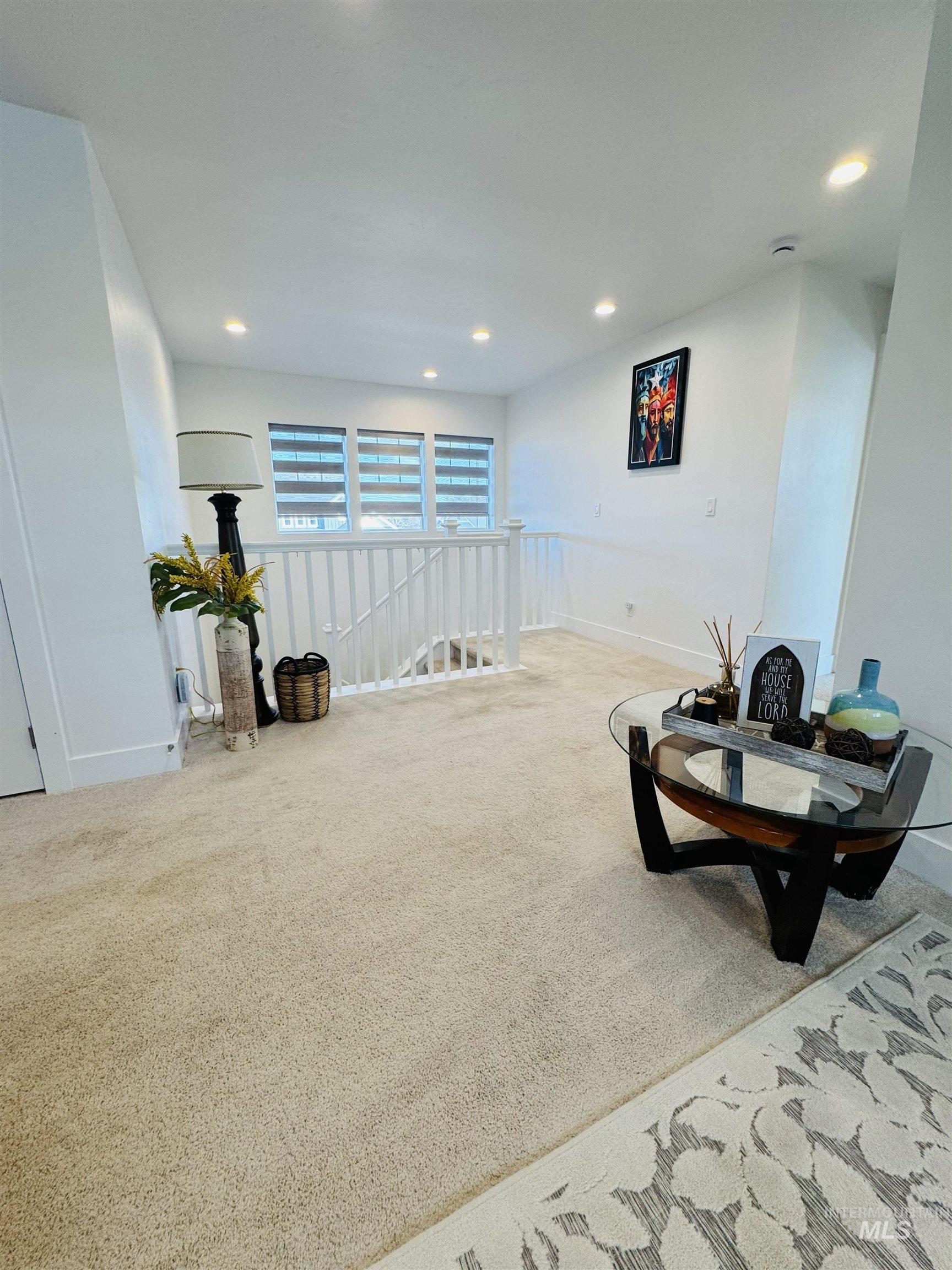 Sitting room featuring recessed lighting, carpet floors, and an upstairs landing