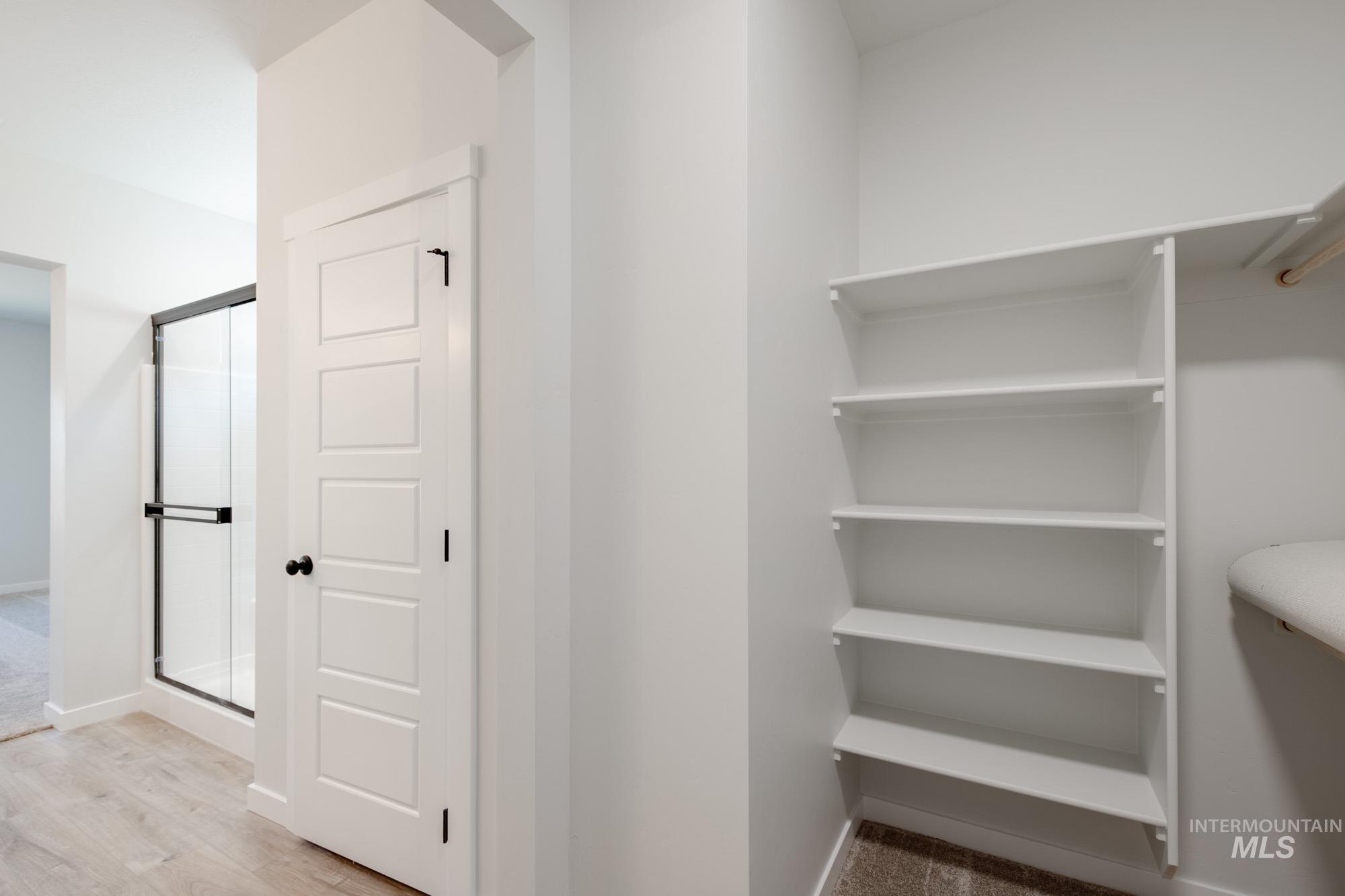 Walk in closet featuring light wood-style floors