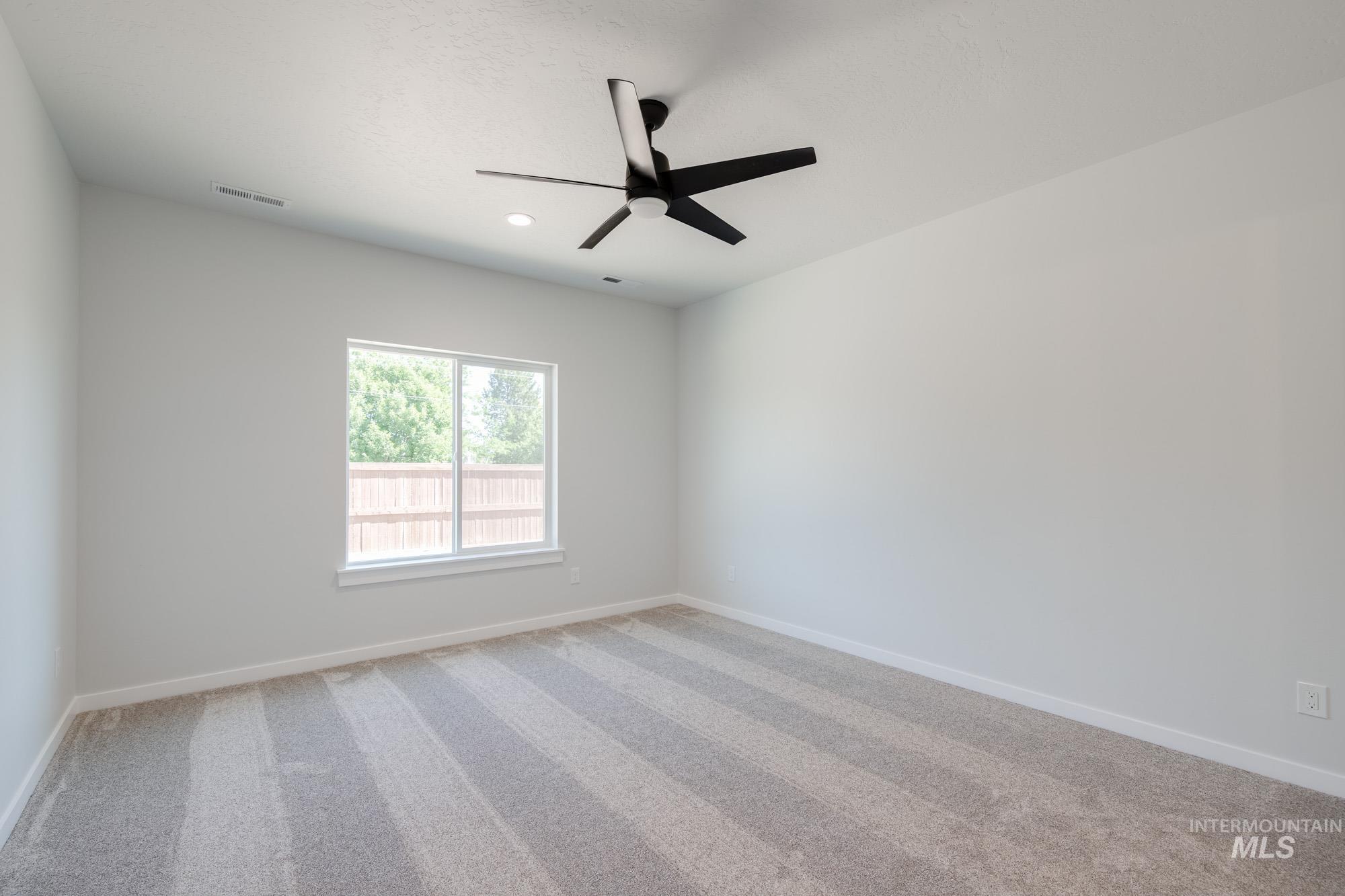 Unfurnished room with light colored carpet, a ceiling fan, and recessed lighting