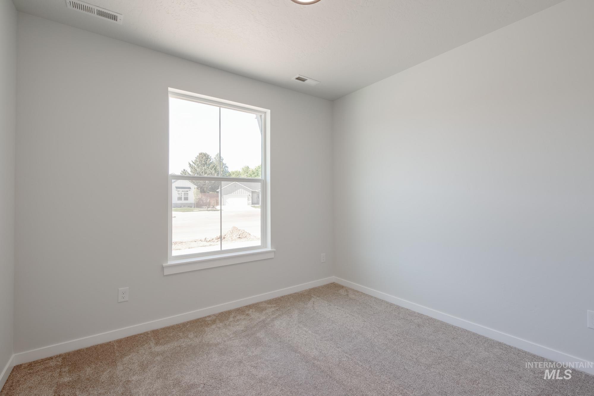 Empty room with baseboards and light carpet