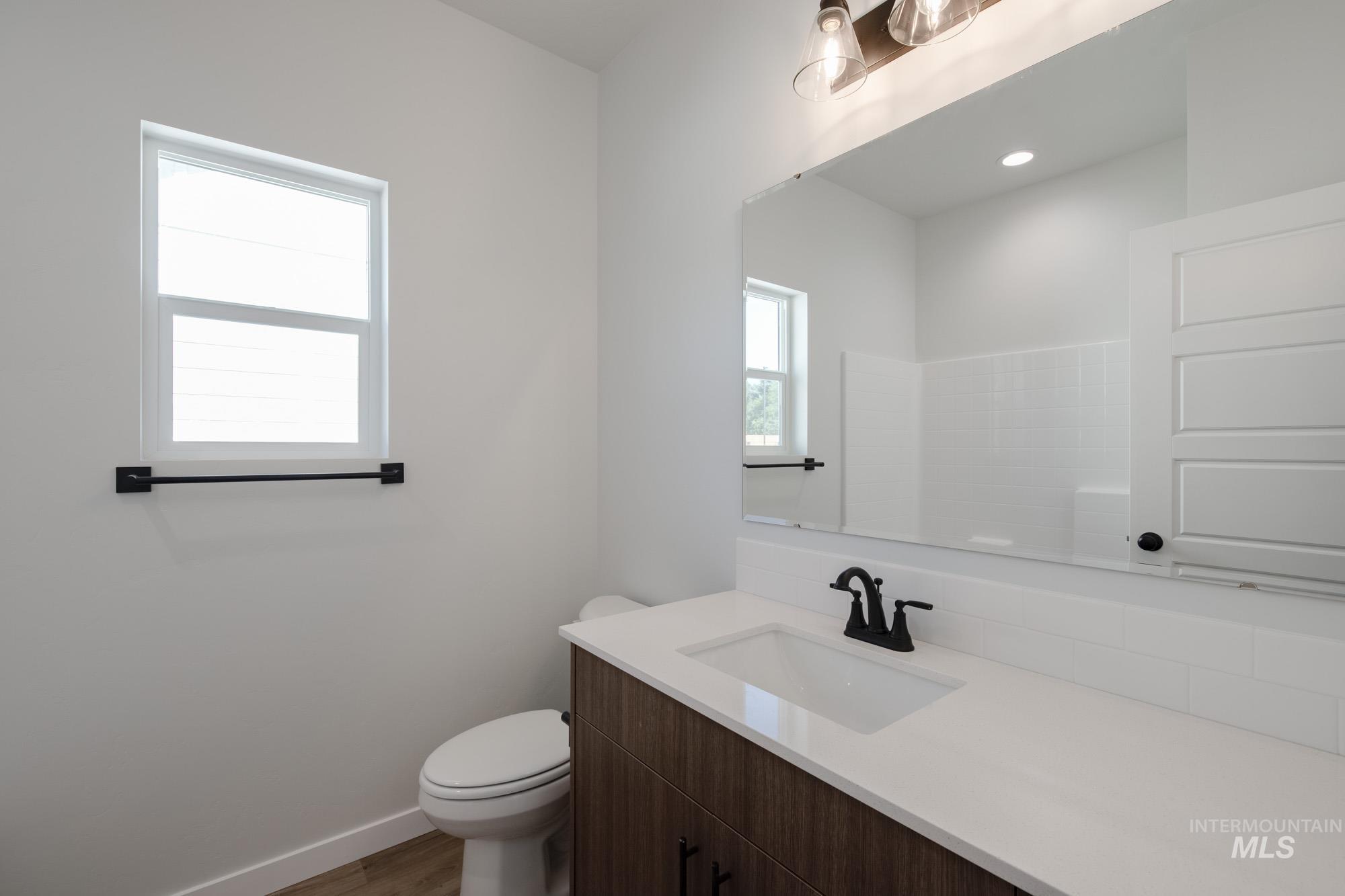 Bathroom with vanity and dark wood-type flooring