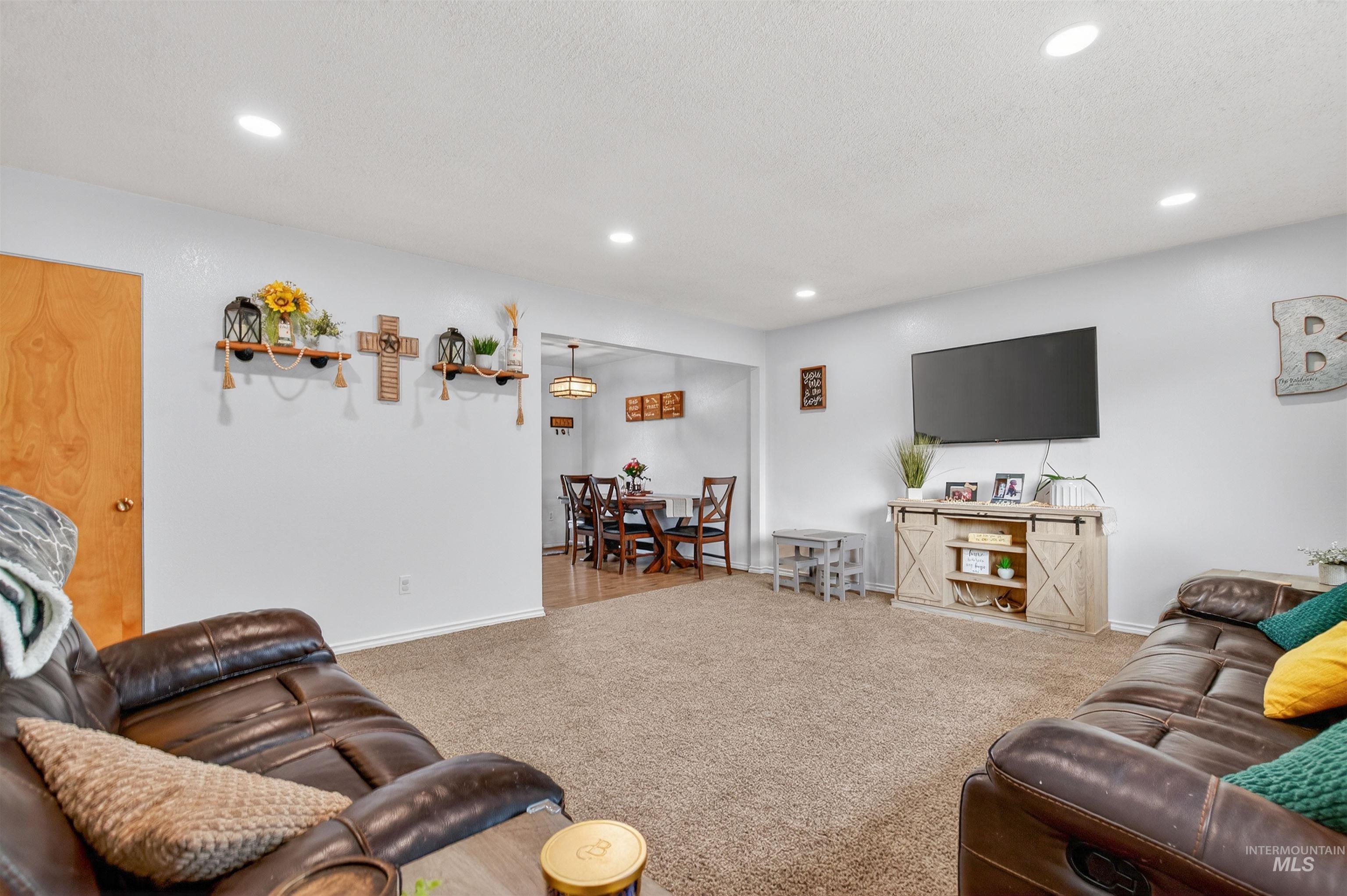 Carpeted living area with recessed lighting