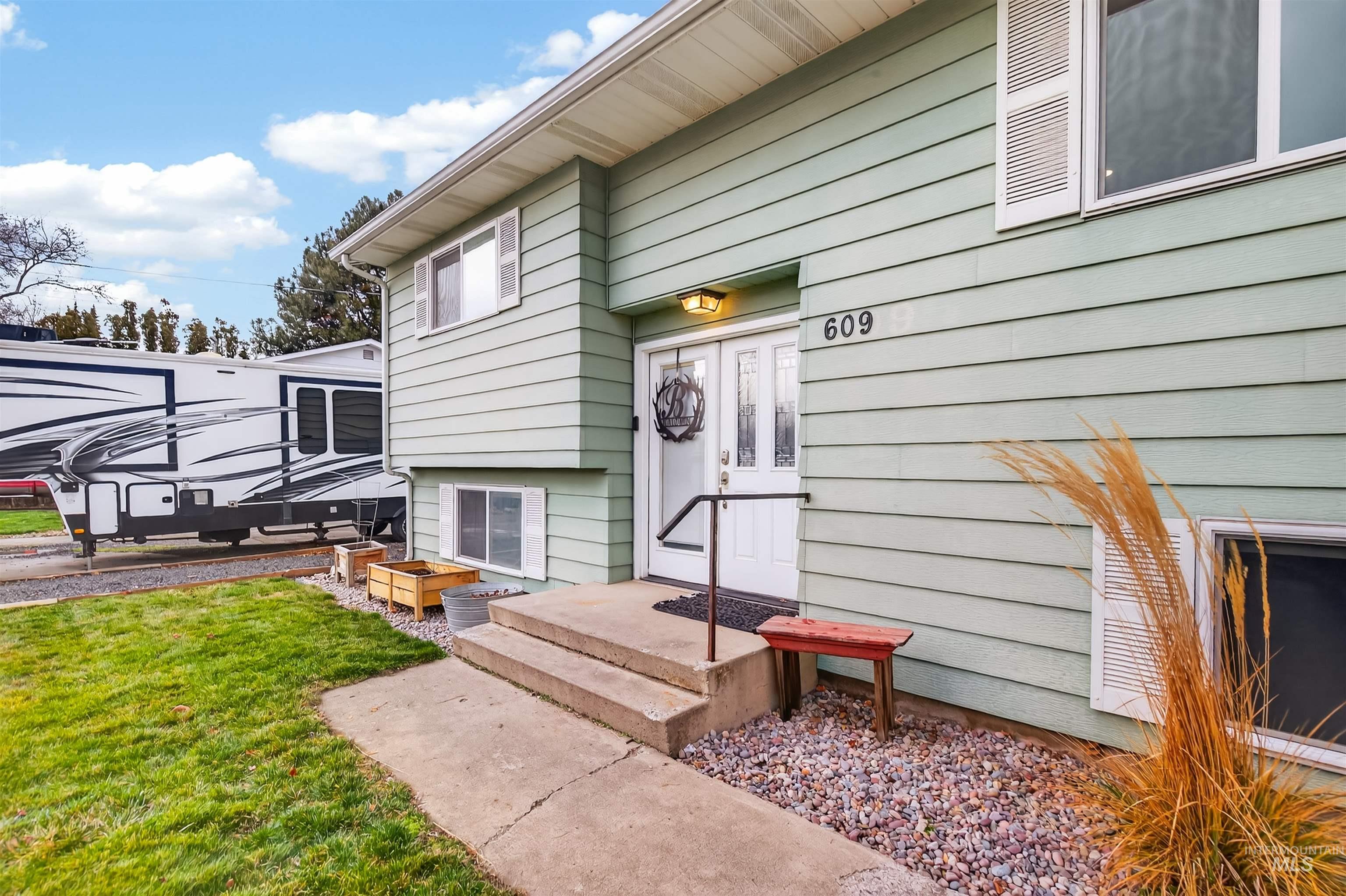 Entrance to property with a lawn