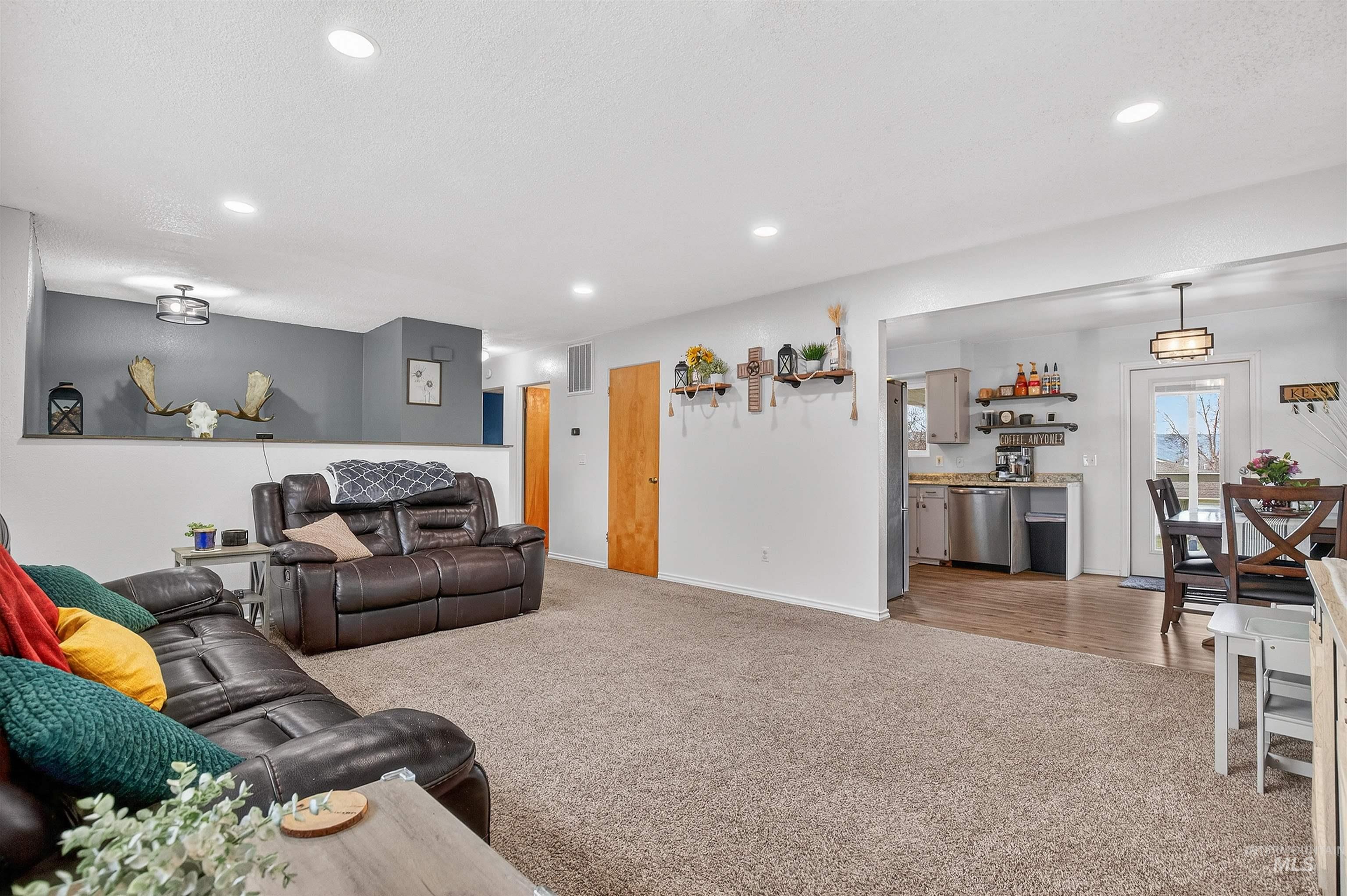 Living room with light carpet and recessed lighting