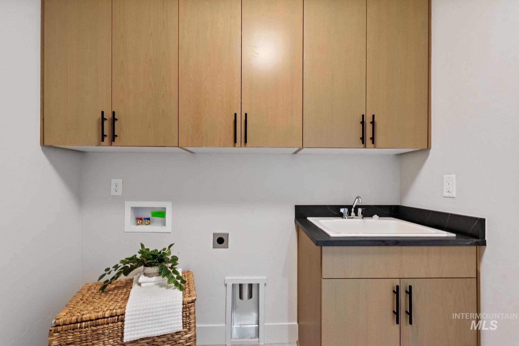 Washroom featuring washer hookup, cabinet space, and electric dryer hookup