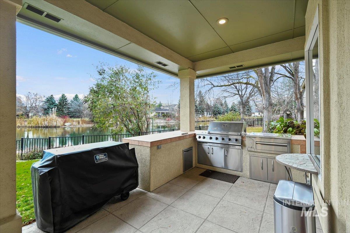 View of patio / terrace with an outdoor kitchen and a water view