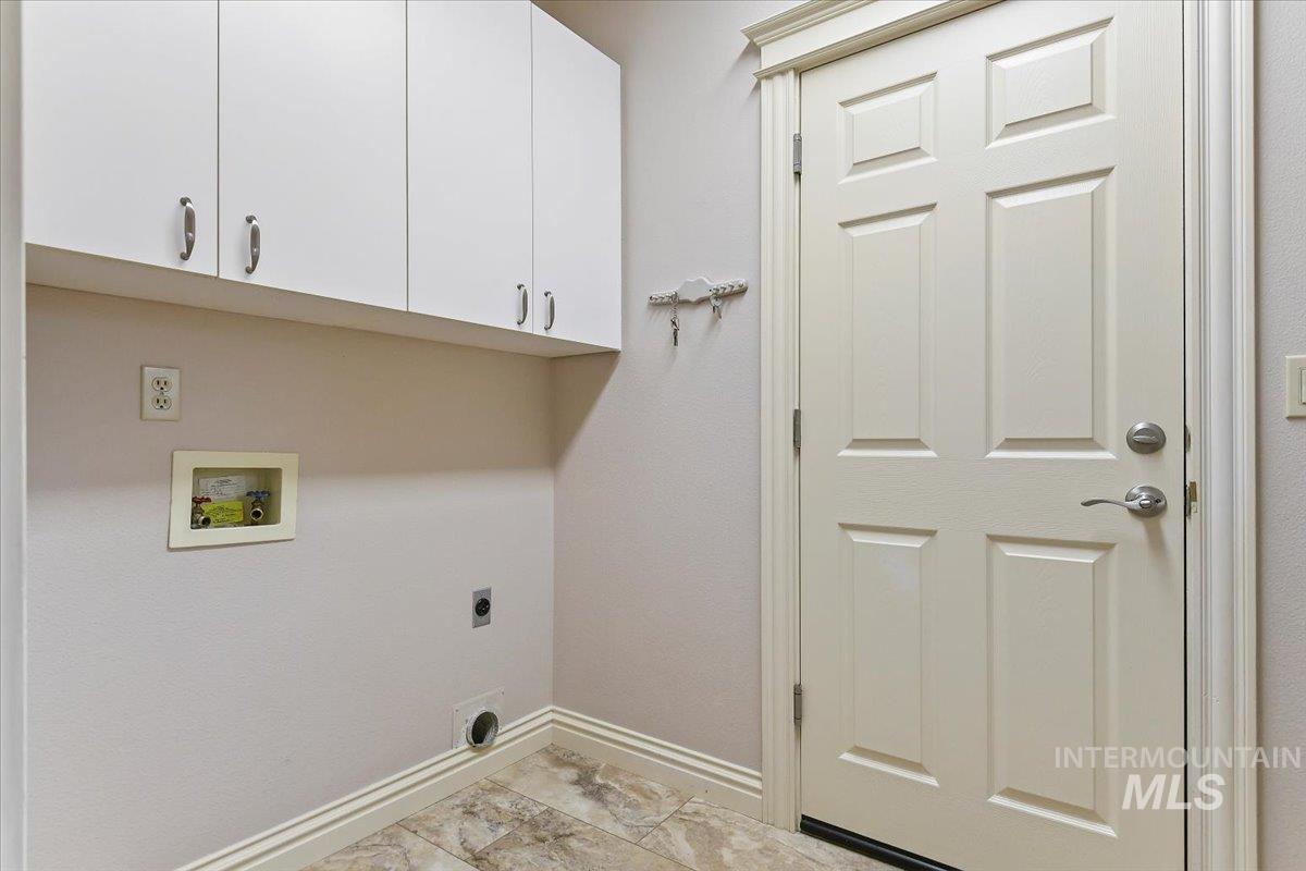 Laundry room featuring cabinet space, electric dryer hookup, and hookup for a washing machine