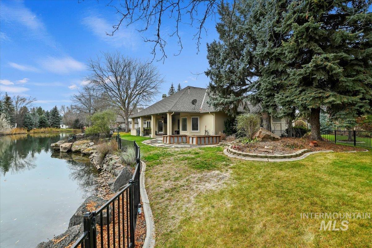 Rear view of property featuring a patio area and a water view