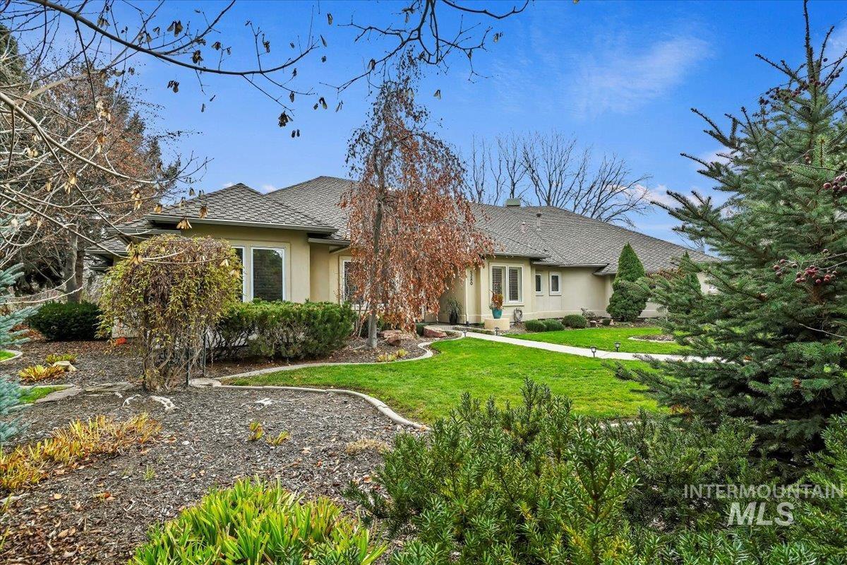View of front of house with a front lawn and stucco siding