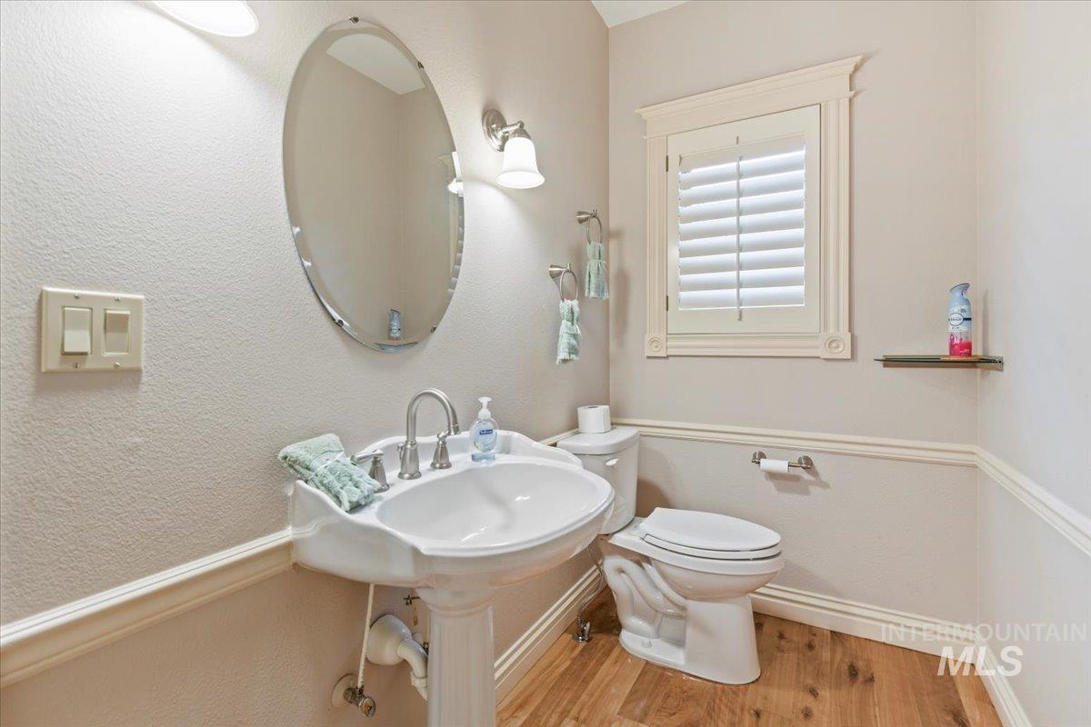 Bathroom with wood finished floors and a textured wall
