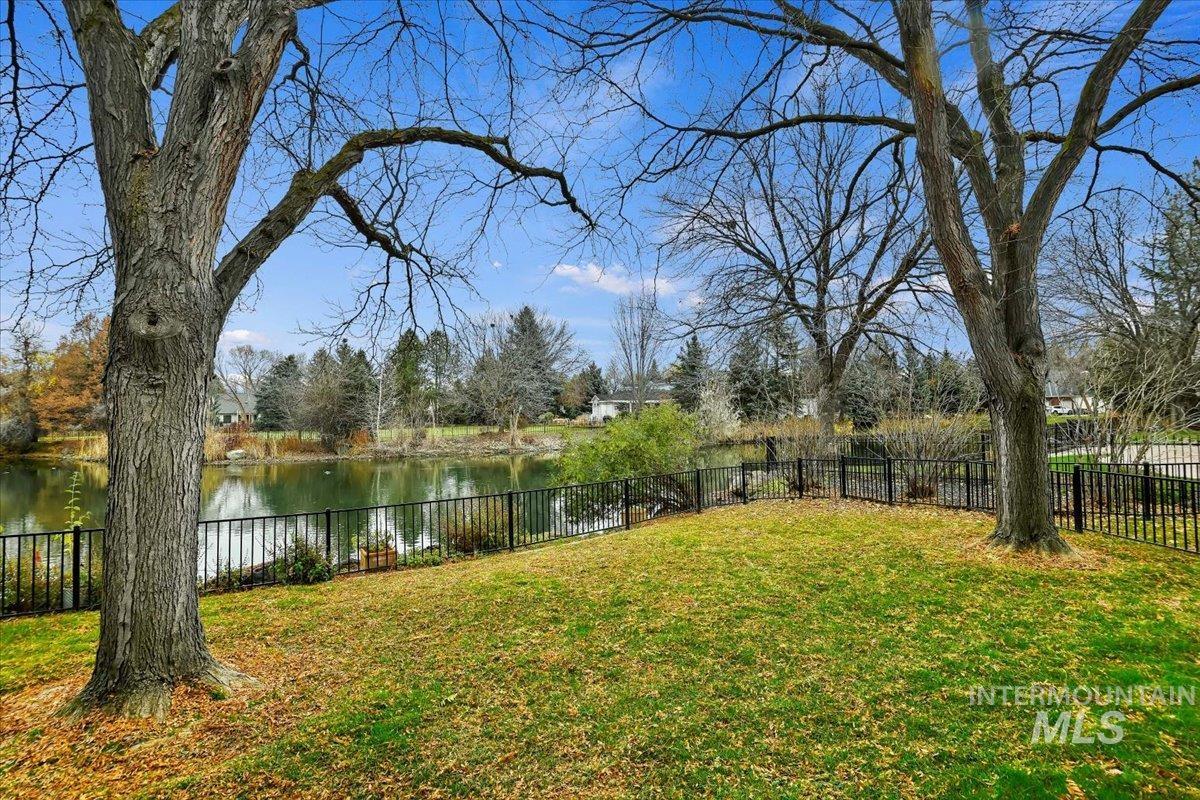 Fenced backyard with a water view