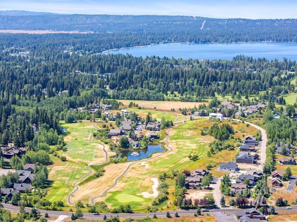 Aerial perspective of suburban area featuring a large body of water and a local golf course