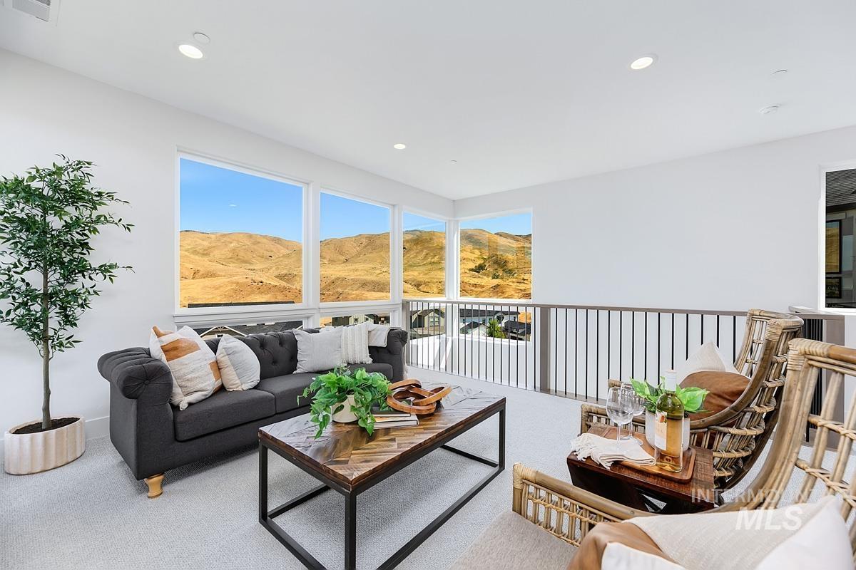 Living room featuring carpet floors, a mountain view, healthy amount of natural light, and recessed lighting