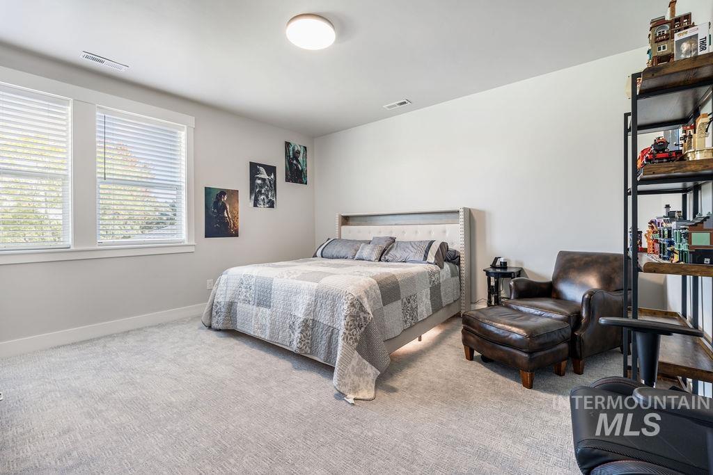 Bedroom with carpet floors and baseboards