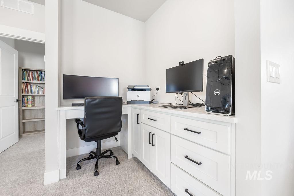 Home office with light colored carpet