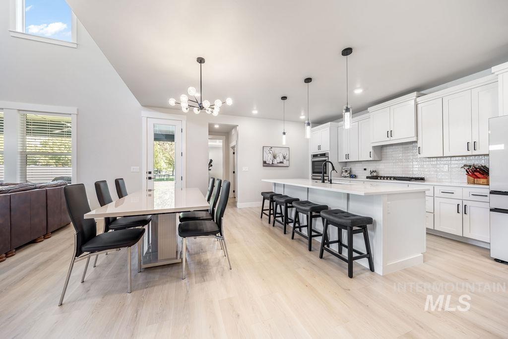 Dining area with light wood finished floors and a chandelier