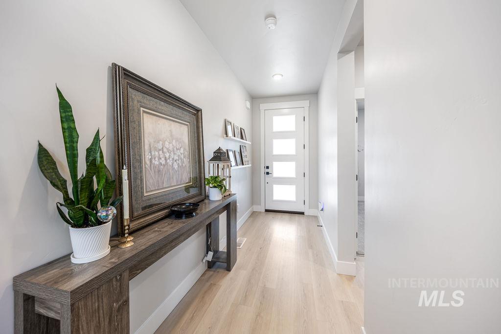 Entryway featuring wood finished floors and baseboards