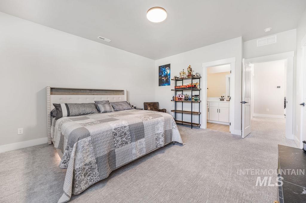 Bedroom featuring light colored carpet and baseboards