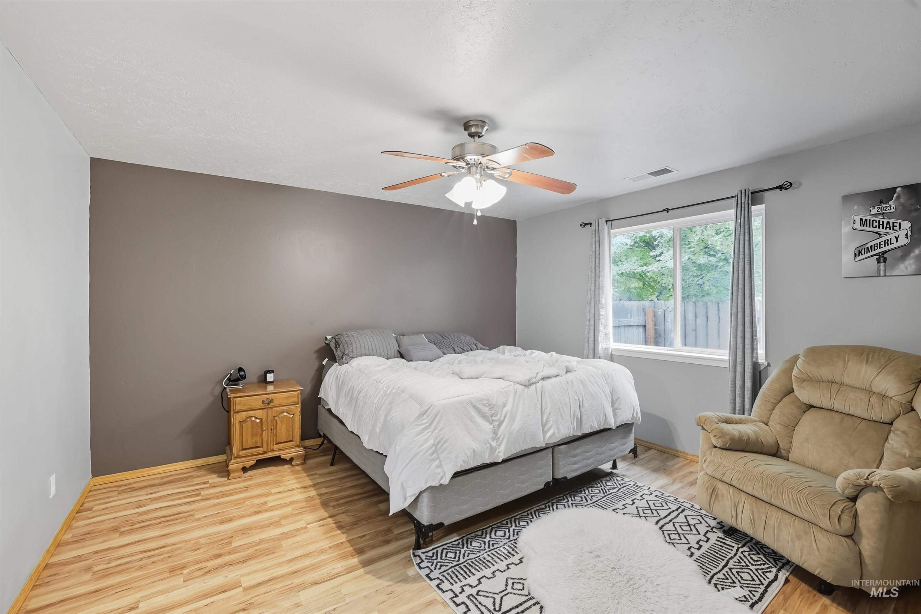 Bedroom with light wood-type flooring and ceiling fan