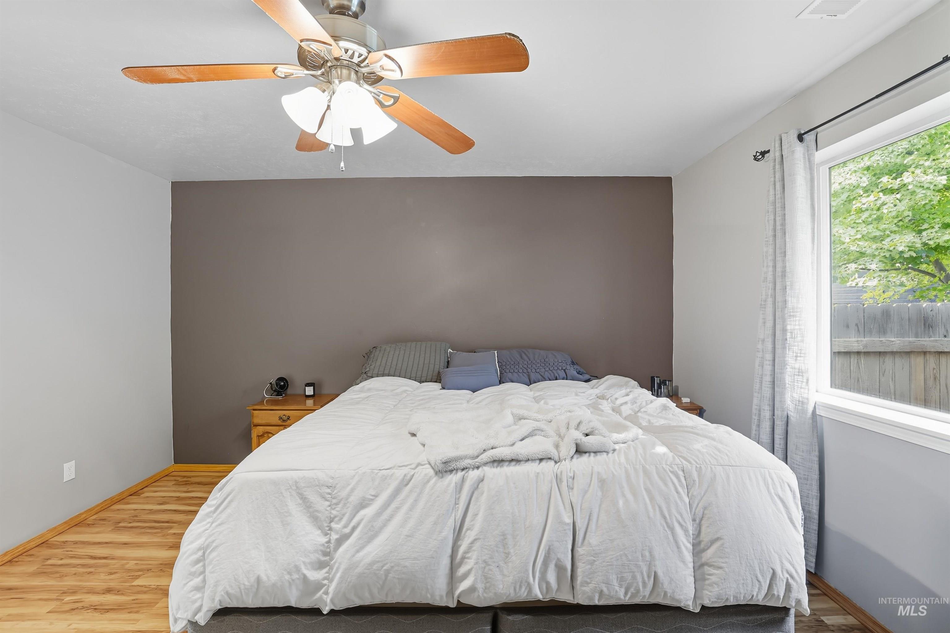 Bedroom with wood finished floors and ceiling fan