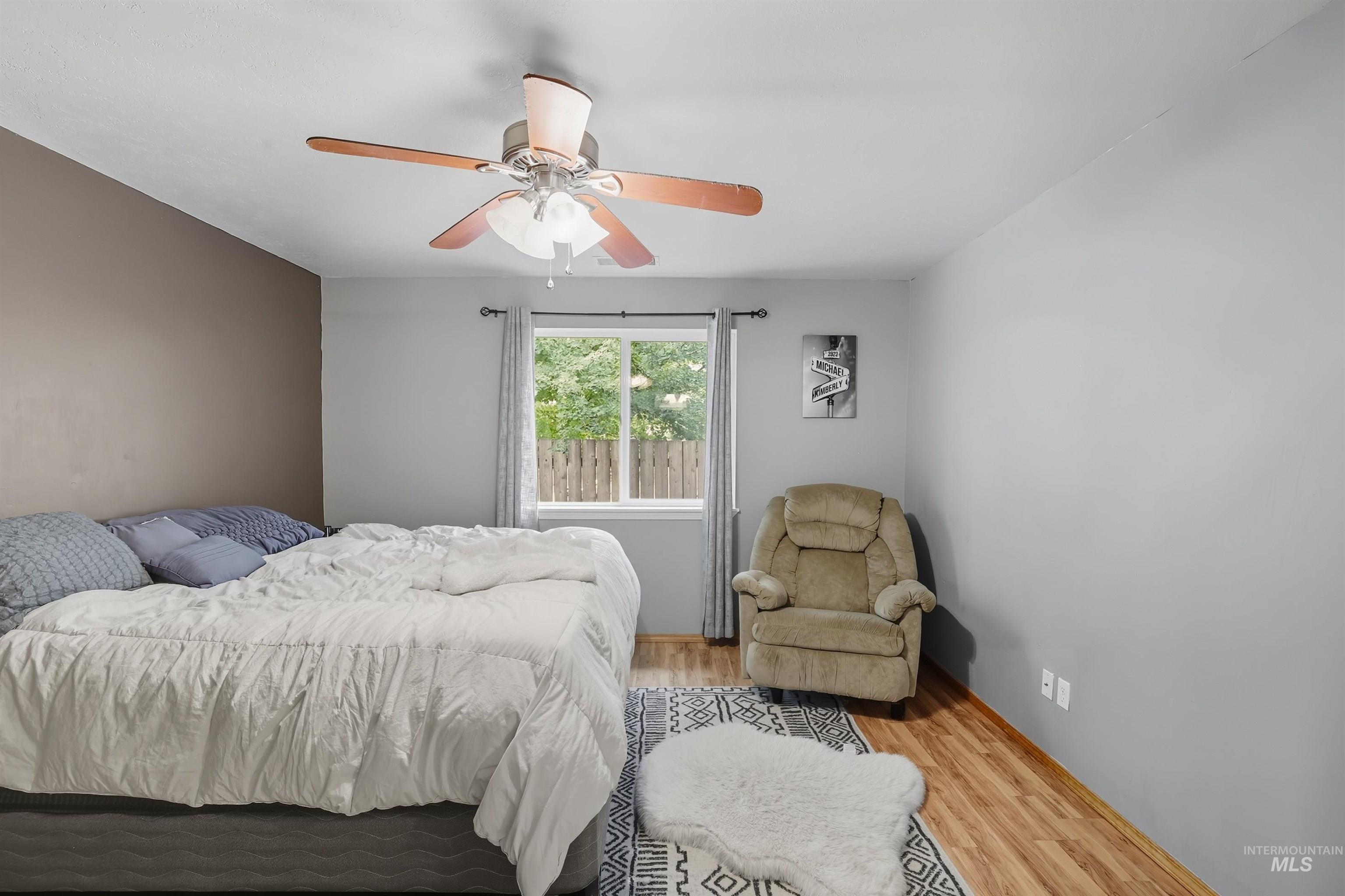Bedroom featuring wood finished floors and ceiling fan