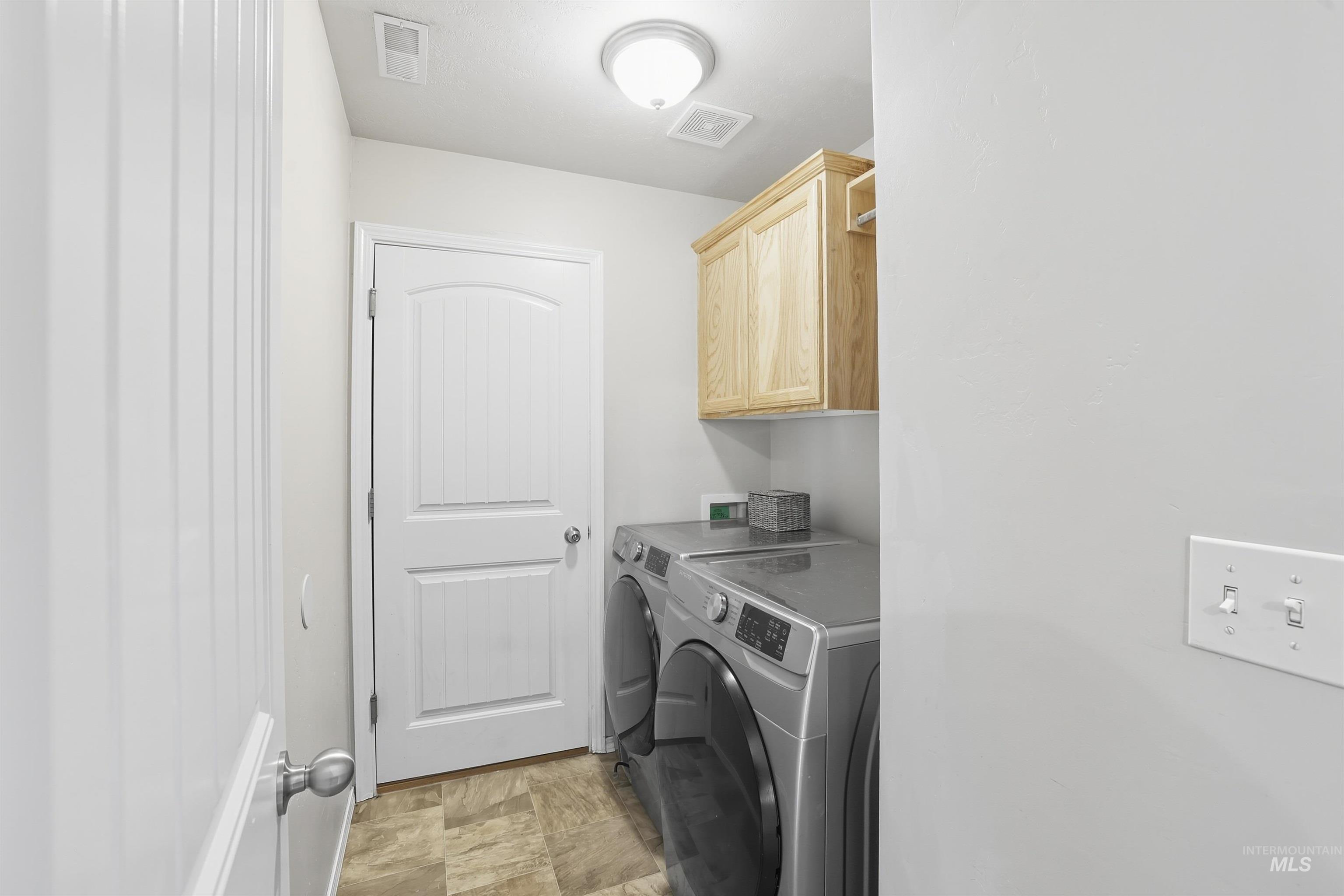 Laundry room with cabinet space and washing machine and clothes dryer