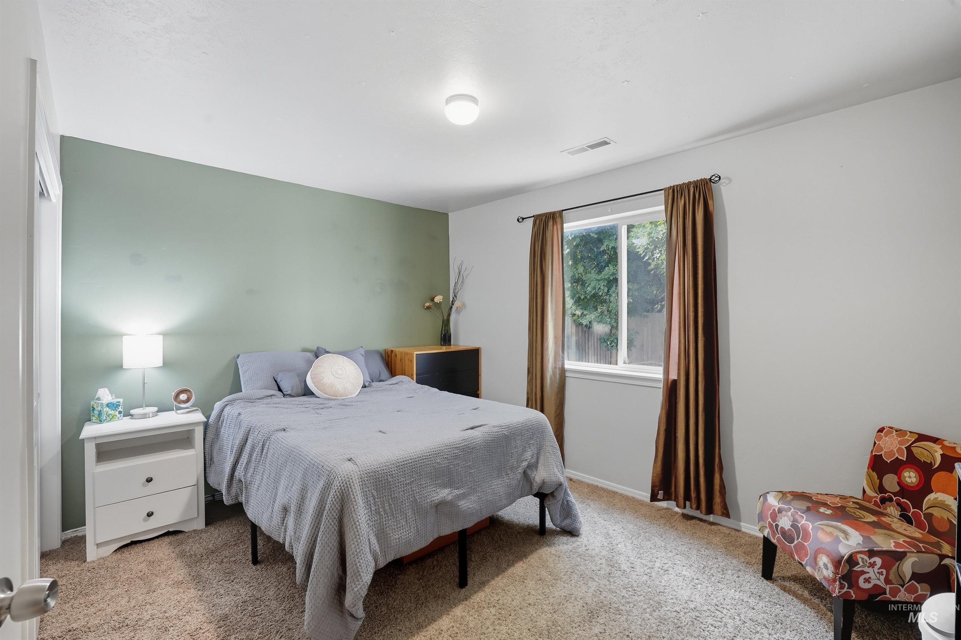 Bedroom with light carpet and baseboards