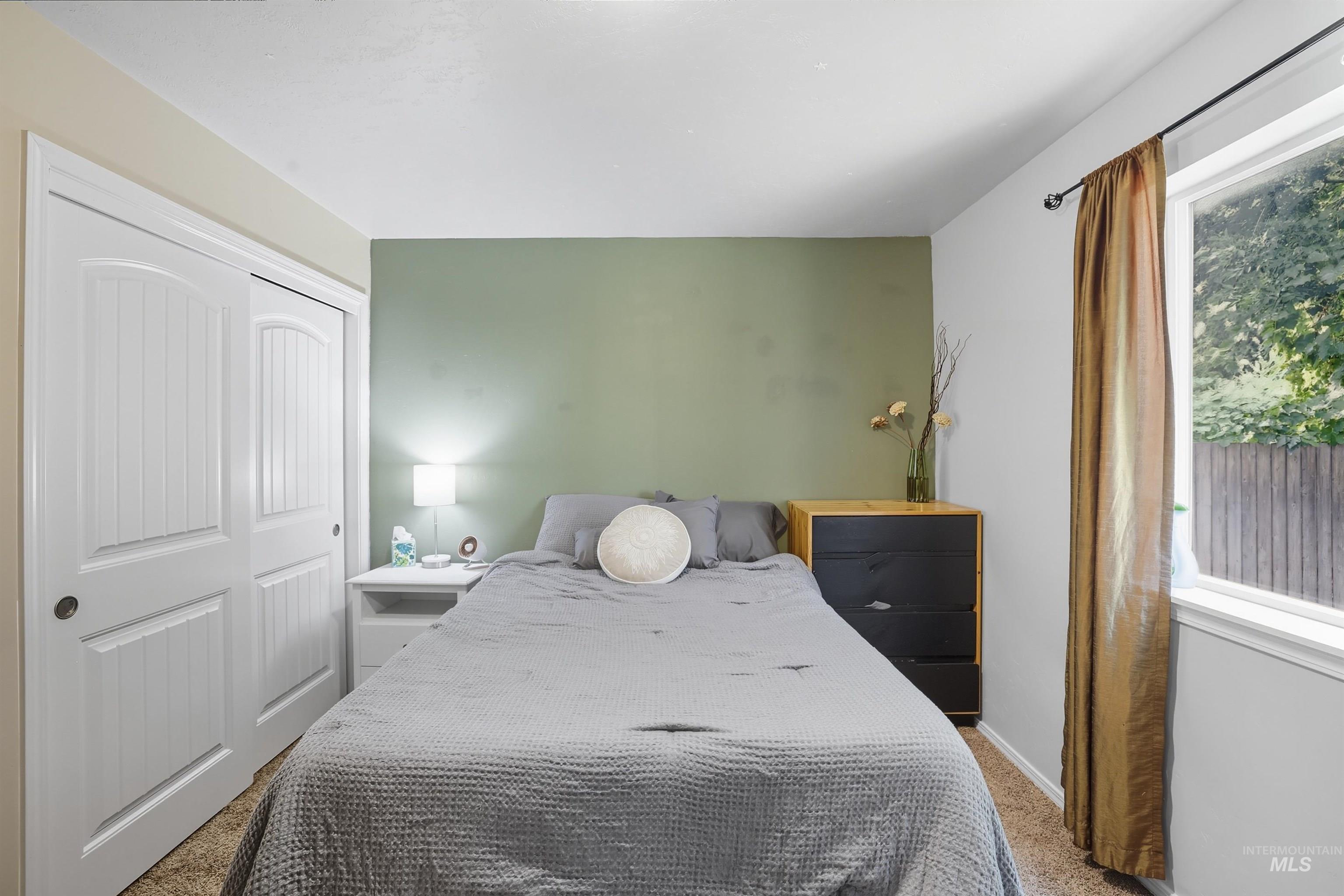 Bedroom featuring carpet and a closet