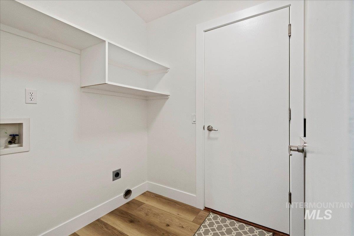 Laundry room with light wood finished floors, electric dryer hookup, and washer hookup