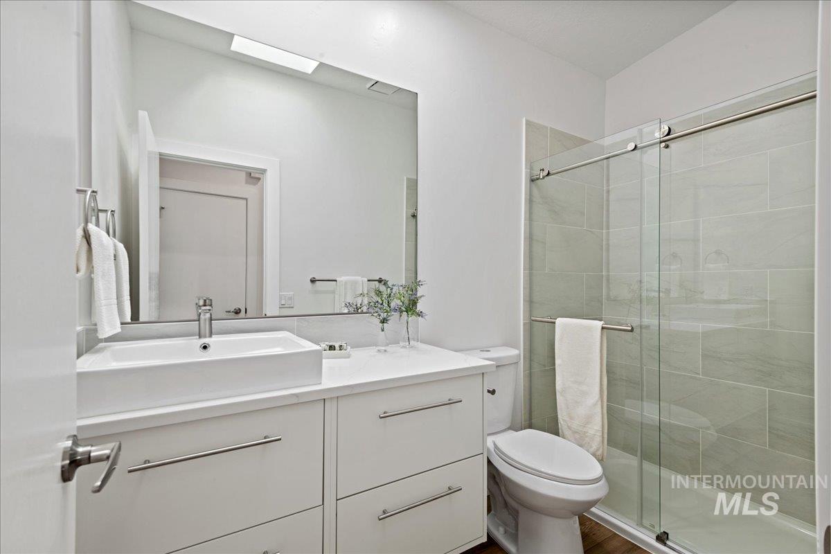 Full bathroom with vanity and a stall shower